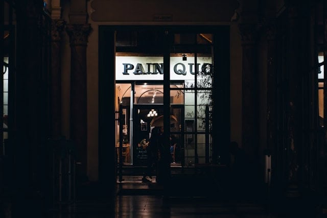people walking in front of a restaurant at night in Paris