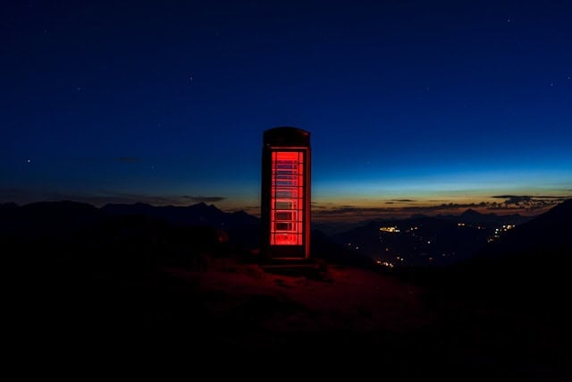 a red phone booth on top of a mountain